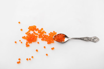 Spoon with delicious red caviar on white background - obrazy, fototapety, plakaty