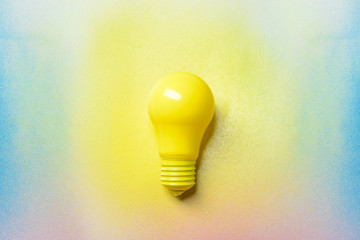 Painted light bulb on light background