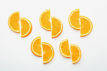 Slices of tasty ripe orange on white background