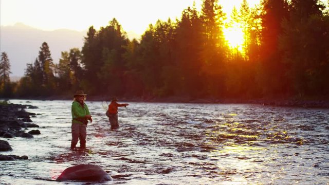 Male female rod and reel fly fishing in freshwater river 