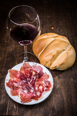 Food such as ham, cheese, chorizo ​​with bread and wine