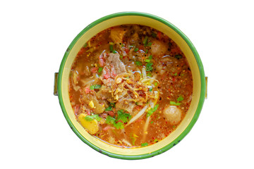 Spicy noodle soup with meat, put the PiSpicy noodle soup with meat, put the Pinto on  a white background.nto on wooden table.