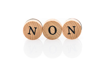 Word Non from circular wooden tiles with letters children toy.