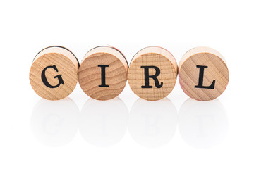 Word Girls from circular wooden tiles with letters children toy.