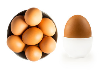 Boiled egg isolated on white background. Boiled egg in eggcup and eggs isolated in wooden bowl . Close-up of an egg isolated on white background. Brown chicken eggs isolated on white.