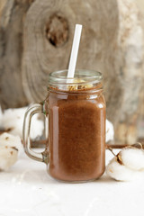 Chocolate banana smoothie on a rustic table