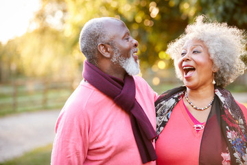 Senior Couple On Autumn Walk In Countryside Together