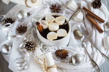 Fototapeta na wymiar A cup of coffee and marshmallow in the New Year table setting