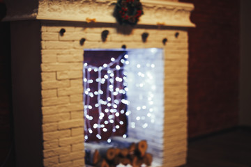 Decorated Christmas room white fireplace, unfocused bokeh