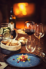 Fototapeta na wymiar Tartare steak with a glass of wine and hornets, product photography for the restaurant, modern gastronomy