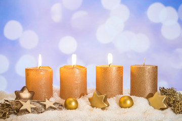 Three golden advent candles lit in snow - 233534139