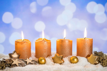 Four golden advent candles lit in snow - 233534323