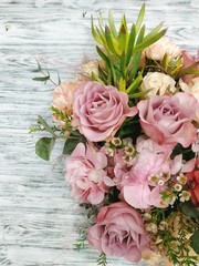 A beautiful floral background: a fresh pastel rose, pink hydrangea with aerial branches, and white chelamilacium. Work in a flower shop. Beautiful idea for a flower frame