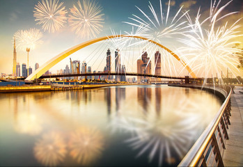 Fototapeta premium fireworks around Tolerance bridge - exotic New Year destination, Dubai, UAE