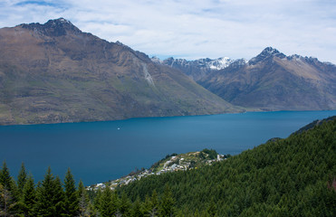 Beautiful view at the Wakatipu Lake, trees and mountains on the way to Ben Lomond near Queenstown in New Zealand