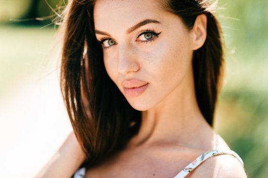 Closeup lifestyle portrait of celebrity female model.  Beautiful girl face on abstract nature background. Cheerful amazing young woman face expression. Sexy blue eyed babe. Glamour youth appearance.