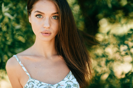 Closeup lifestyle portrait of celebrity female model.  Beautiful girl face on abstract nature background. Cheerful amazing young woman face expression. Sexy blue eyed babe. Glamour youth appearance.