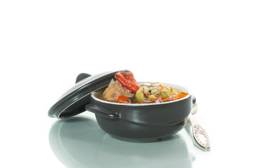vegetable soup with meatballs and pepper in a plate