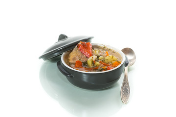 vegetable soup with meatballs and pepper in a plate