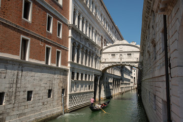 Fototapeta na wymiar Venetian canal with covered bridge and gondola, Bridge of Sighs, Venice, Veneto, Italy