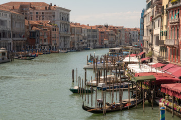 View of Grand Canal in Venice with docked gondolas and boats in summer, Venice, Italy