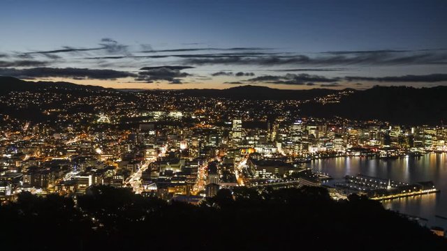 City lights of Wellington, New Zealand at nightfall. Timelapse video of beautiful view from Victoria Hill right above the city centre.