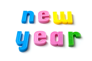 closeup of colorful plastic letters on white background - new year