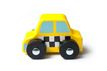 closeup of miniature wooden car on white background - concept taxi