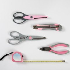 Pink feminine handy tools on a white background