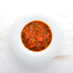 Vegetable soup kharcho. On the old wooden background. Free space for text. Top view.