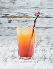Cocktail Sex on the Beach. Orange juice, vodka, grenadine. On a wooden background. Top view.