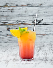 Taylor Cocktail Orange juice, gin and grenadine. Alcoholic cocktail in a glass. On a wooden background. Top view. Free copy space.