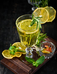 Hot white wine and rosemary cocktail. On a wooden background. Top view. Free copy space.