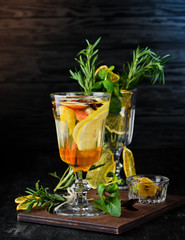 Hot cocktail of white wine, honey and lemon. On a wooden background. Top view. Free copy space.