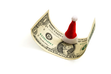 Red Santa Claus souvenir hat in the center for one dollar bill. The concept of financial costs for...