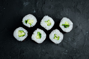 Vegetarian sushi roll with cucumber. Japanese cuisine. Top view. © Yaruniv-Studio
