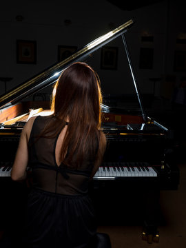Female pianist performing on a concert piano