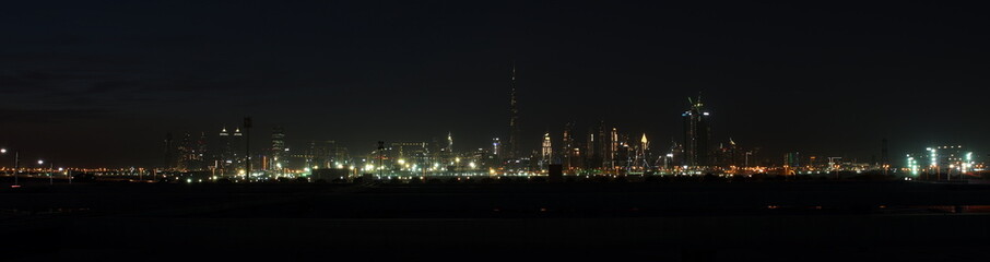Fototapeta na wymiar Dubai skyline at night from Al Meydan Hotel and district, Dubai downtown and Business Bay area