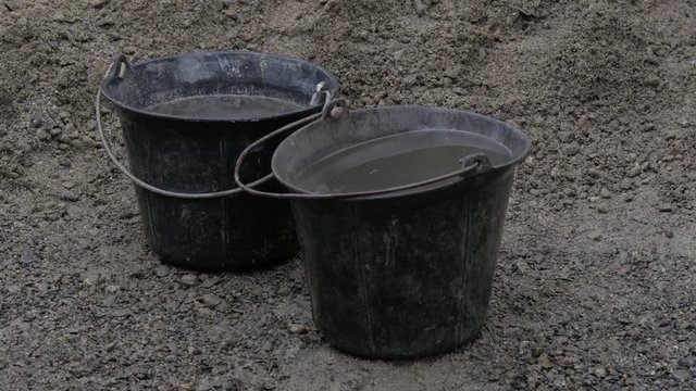 two buckets full of water for concrete