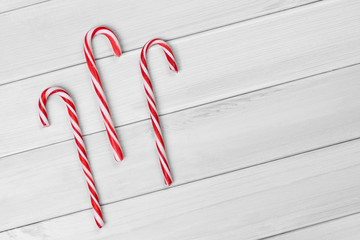 Christmas candies on white wooden background