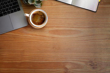 Overhead shot of wooden table workspace and office supplies