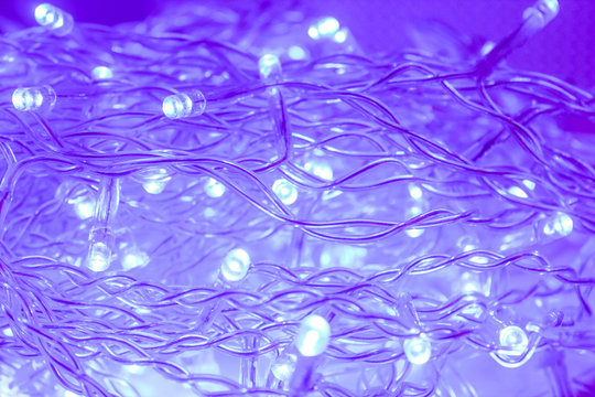 Tangled New Year's neon blue garland of small bright light bulbs. Getting ready for the new year is a great way to create a party atmosphere with lighting.