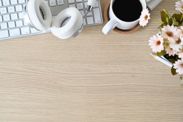 Overhead shot of wooden table workspace and office supplies