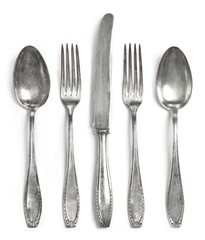 Vintage cutlery, silverware. Old silver cutlery, isolated on white background. Top view of table...
