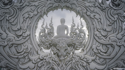 Incredible patterns in a white temple in Chiang Rai. Buddha sits with his back to the camera. Asia Travel