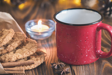 Tea mug with homemade oatmeal cookies, cinnamon and anise seeds