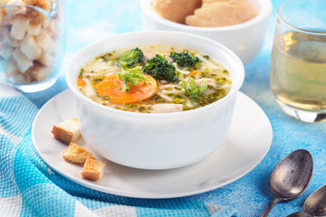 Italian vegetable soup with broccoli carrots and noodles in chicken broth