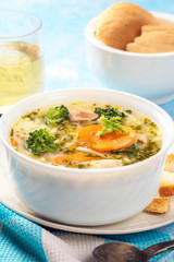 Italian vegetable soup with broccoli carrots and noodles in chicken broth
