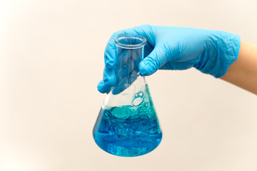 hand in glove holding test tube in the laboratory