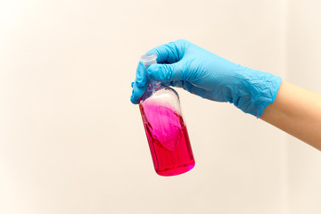hand in glove holding test tube in the laboratory